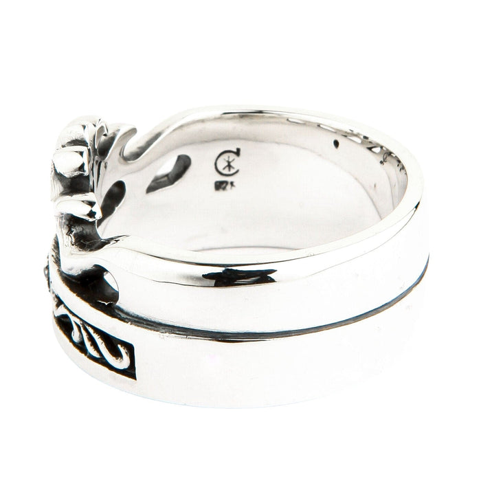 Interior detail of the wide silver band displaying a 925 hallmark and maker's mark on the smooth polished metal.