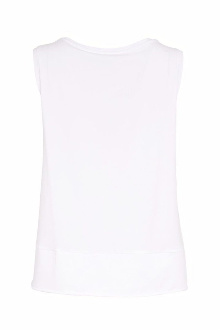White Naya cami top with wide straps, layered raw hem and back vent. Soft, flattering and perfect for layering. Shop at Dotique.