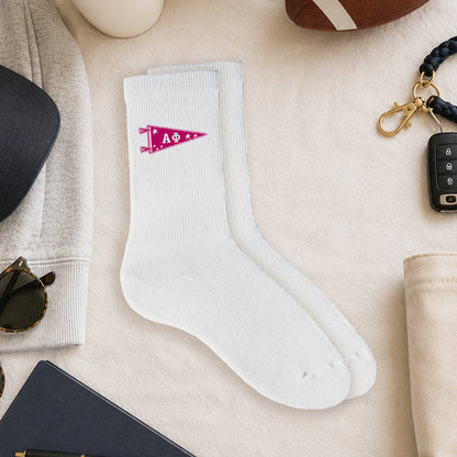 Alpha Phi collegiate pennant crew socks styled in a sorority flat lay with Greek life accessories