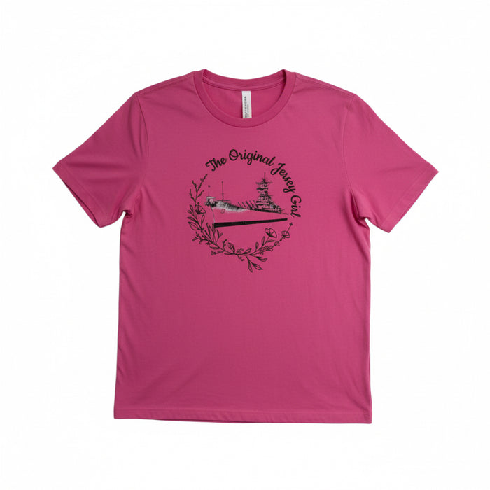 A pink short-sleeved T-shirt with a graphic print of the Battleship New Jersey and the text 'The Original Jersey Girl'.