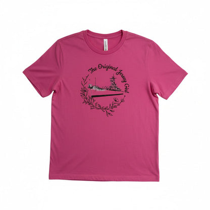 A pink short-sleeved T-shirt with a graphic print of the Battleship New Jersey and the text 'The Original Jersey Girl'.