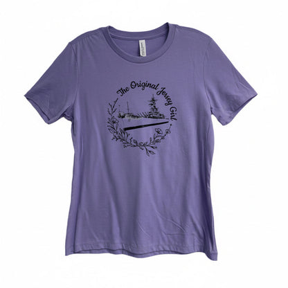A purple crew neck t-shirt with a graphic print of the Battleship New Jersey and the text 'The Original Jersey Girl'.
