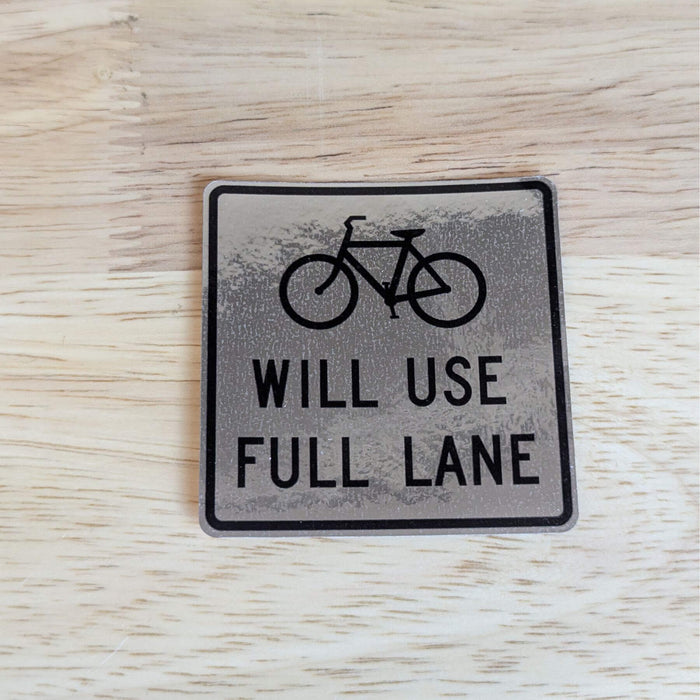 reflective bike sticker on wood background
