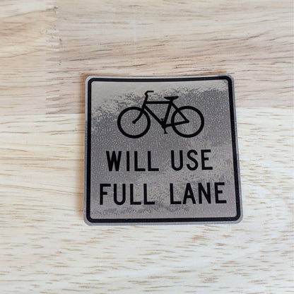 reflective bike sticker on wood background