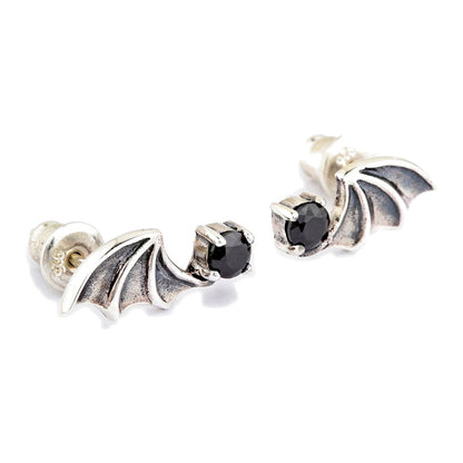 Angled pair of gothic bat wing studs, with a sterling bullet clutch and the 925 stamp visible behind the left wing