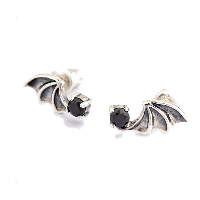 Oxidized membrane panels sit between polished silver ribs on both wings, with the black cubic zirconia held in four prongs