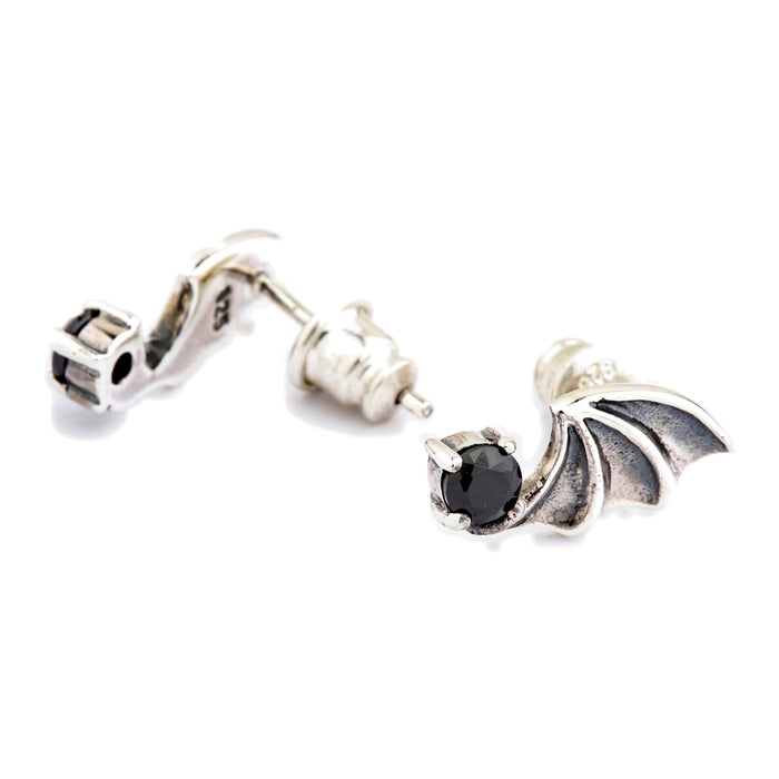 Sterling silver bat wing earring seen front and reverse, showing the cylindrical post that lets the wing rotate