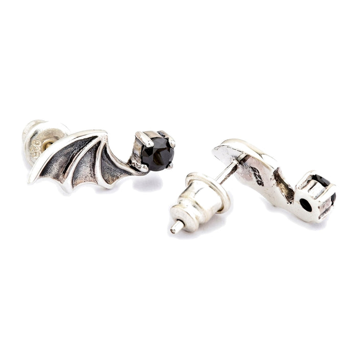 Post and bullet clutch detail, with one clutch pulled off the post beside the reverse of the second earring