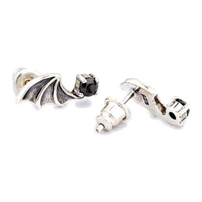 Post and bullet clutch detail, with one clutch pulled off the post beside the reverse of the second earring