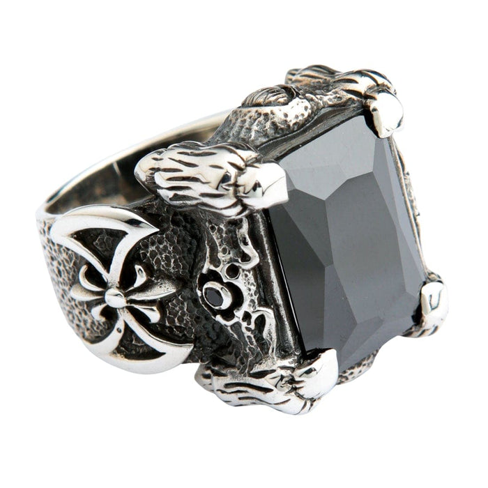 A detailed gothic dragon ring with a huge black gemstone, featuring intricate scales and a warrior's battle axe emblem.