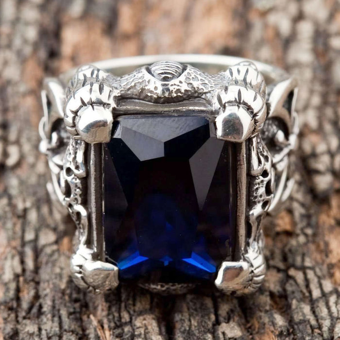 The gothic dragon ring, showing its impressive size and the side axe and fleur-de-lys motif.