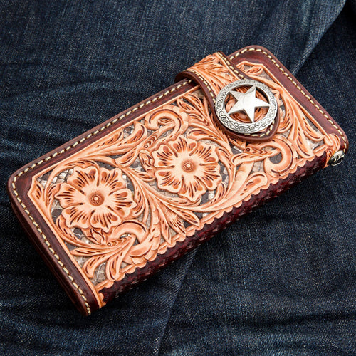 Angled view of the brown leather biker wallet showing intricate floral tooling and snakeskin-texture inlay.