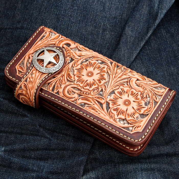 Side profile of the tooled leather wallet showing the thickness and edge stitching.