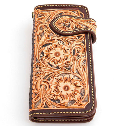 Carved floral and scroll tooling across the brown leather, with contrast stitching and a layered inlay panel.