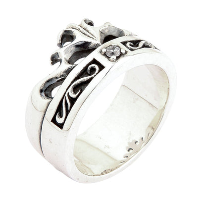 Close-up angle revealing the thick polished silver base below a recessed oxidized knotwork channel and cubic zirconia.