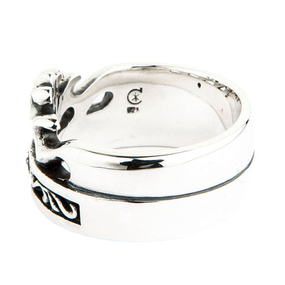 Interior detail of the wide silver band displaying a 925 hallmark and maker's mark on the smooth polished metal.
