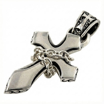 Close-up detail of the miniature silver chain wrapped around the gothic cross pendant.