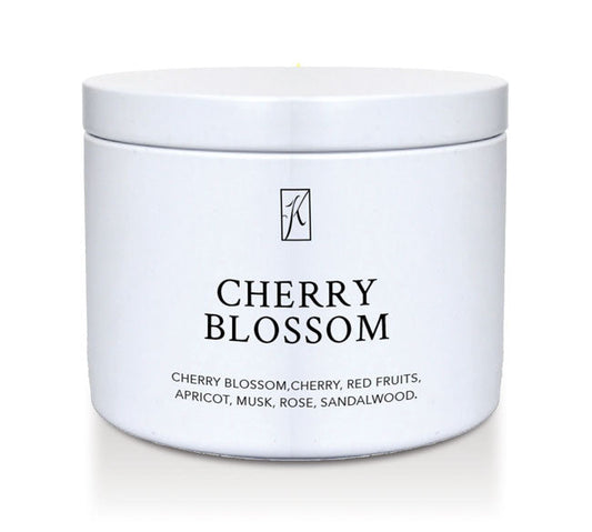 White tin container with 'Cherry Blossom' fragrance description on a white background