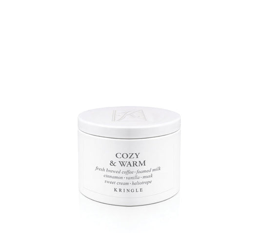 A white round cosmetic jar with a matching lid, labeled 'COZY & WARM' by Kringle, on a seamless white background.