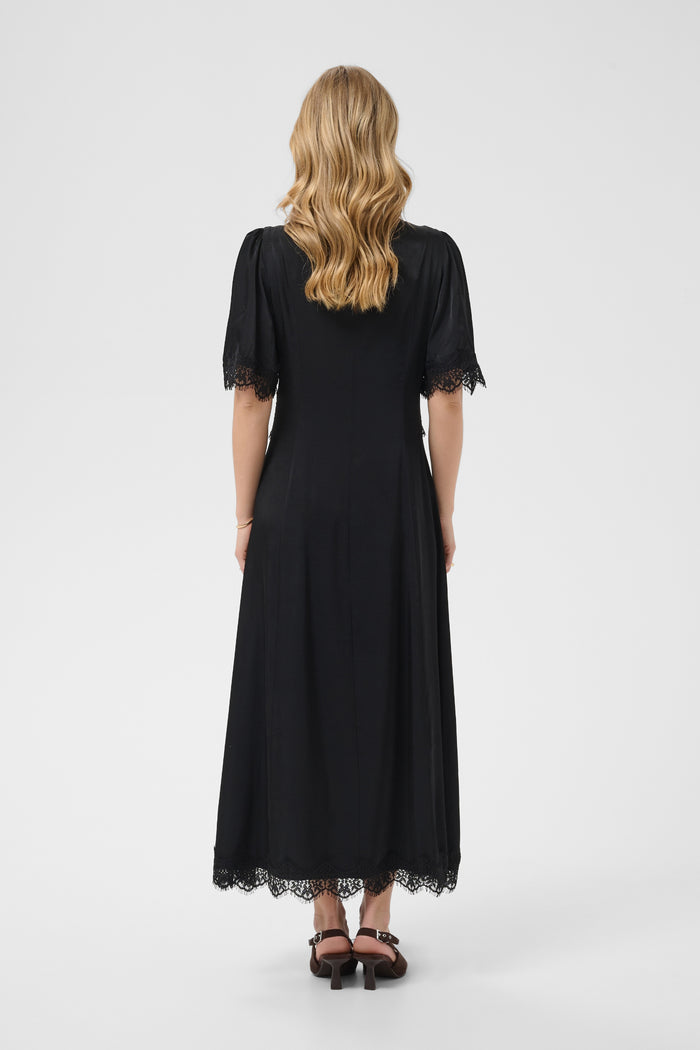 Cream 10615319 Confir Lace Maxi Dress Black on model from behind with lace trim. Shop Cream at Dotique.