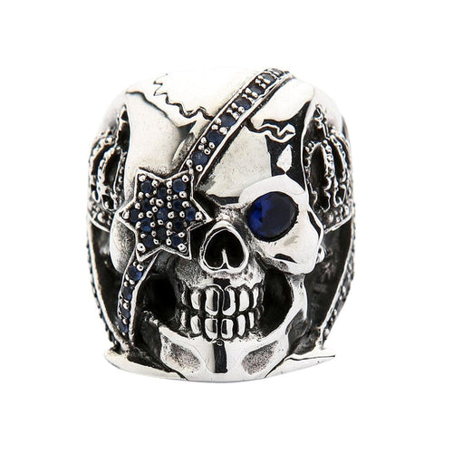 Front face view of the skull ring with blue sapphire CZ stones in the eye and patch.