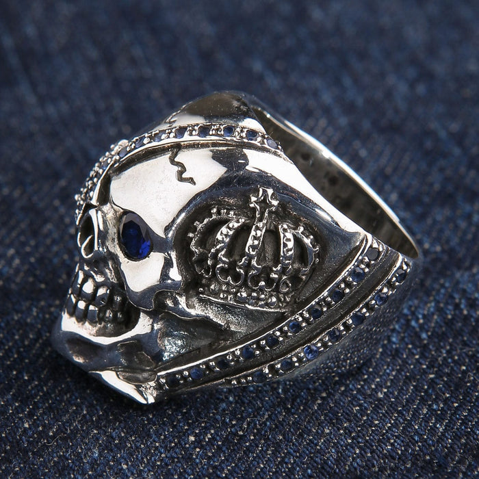 Side view highlighting the detailed royal crown carving on the silver skull ring.