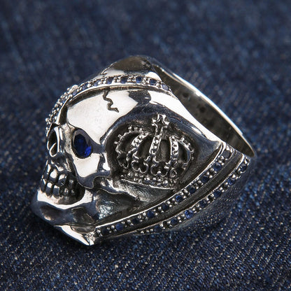Side view highlighting the detailed royal crown carving on the silver skull ring.