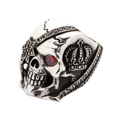 An angle shot focusing on the red stone setting, crown design and polished silver teeth.