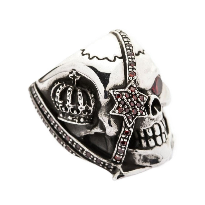 Side view of the crown skull ring showing the detailed royal crown carving and red stones.