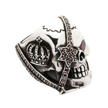 Side view of the crown skull ring showing the detailed royal crown carving and red stones.