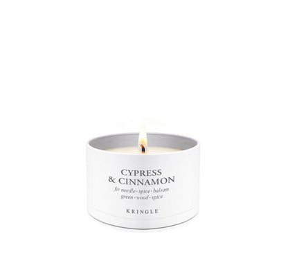Cypress & Cinnamon Scent in mini candle tin lit single-wick on a white background by Kringle Candle