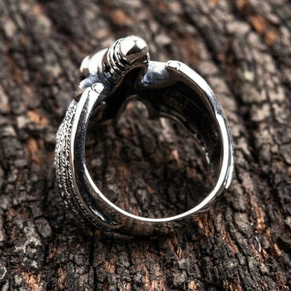 Interior view of the heavy sterling silver band showing the smooth finish and structural thickness resting on textured wood.