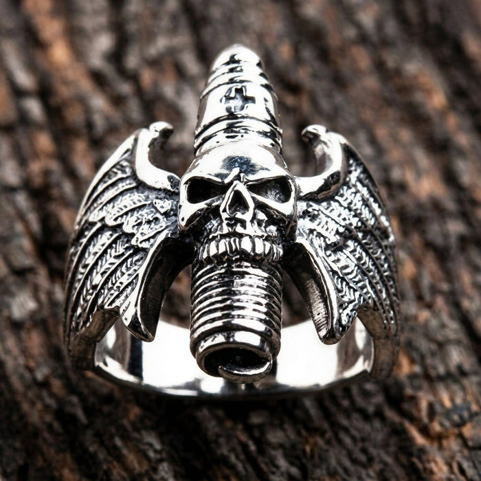 Upright display of the .925 silver ring showcasing symmetrical feathered wings and a vertical ribbed skull centerpiece.