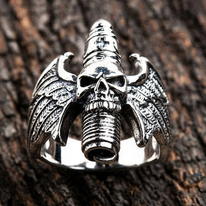 Upright display of the .925 silver ring showcasing symmetrical feathered wings and a vertical ribbed skull centerpiece.