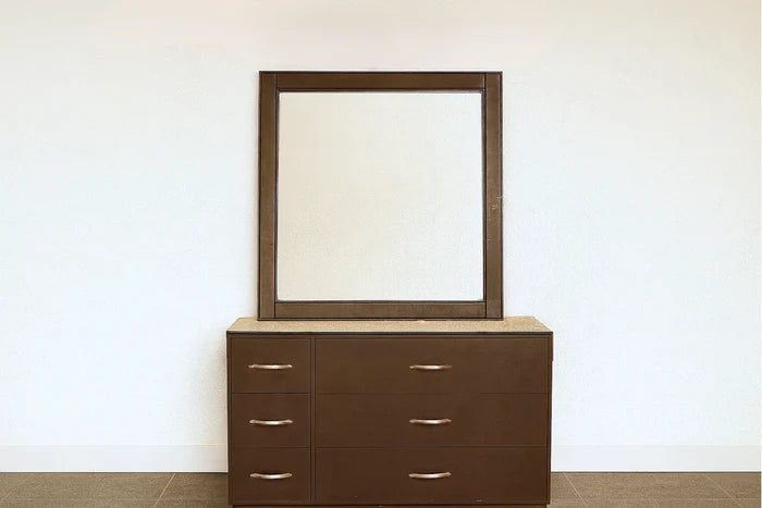Brown dresser with drawers and a matching framed mirror