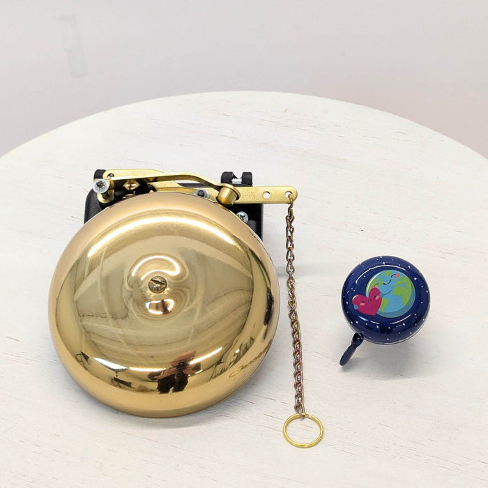 Huge bike bell next to regular bike bell
