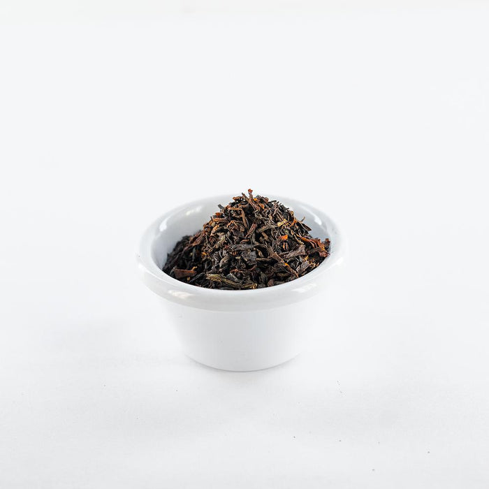 White ramekin filled with loose earl grey black tea