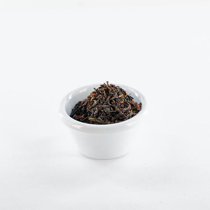 White ramekin filled with loose earl grey black tea