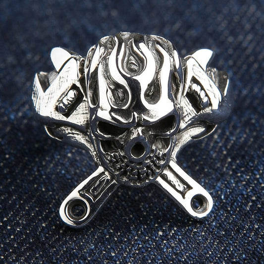 925 sterling silver flaming skull ring with crossed wrenches front view on denim background