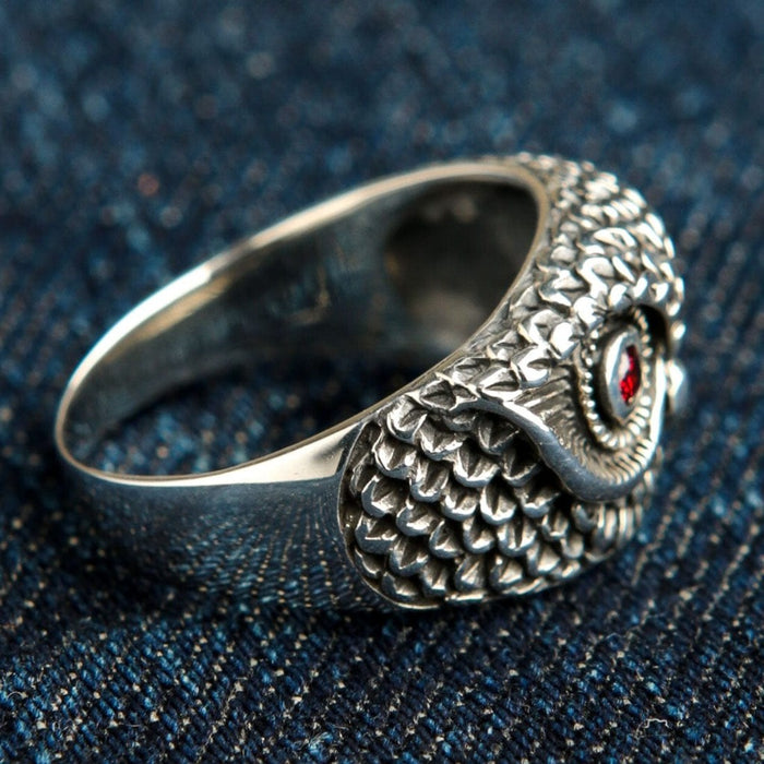 Back angle view of sterling silver owl ring showing scaled feather design wrapping around band