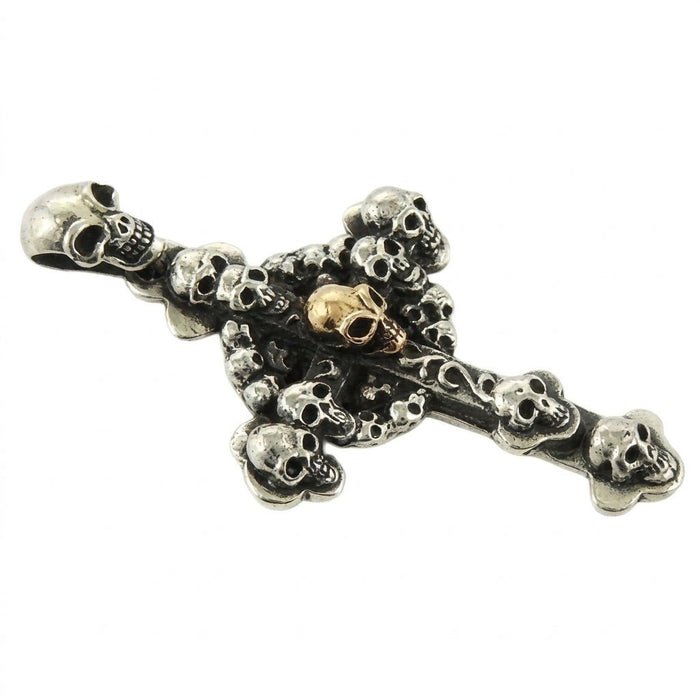 Angled flat lay highlighting the skull-shaped bail and layered 3D design of the oxidized silver cross pendant.