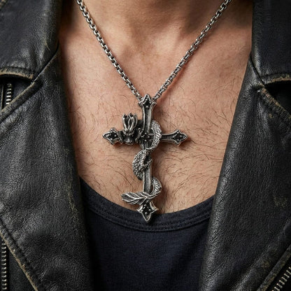 Close-up of a man wearing a black leather motorcycle jacket, modeling a large silver gothic cross pendant featuring a detailed wrapped dragon design on a silver chain.