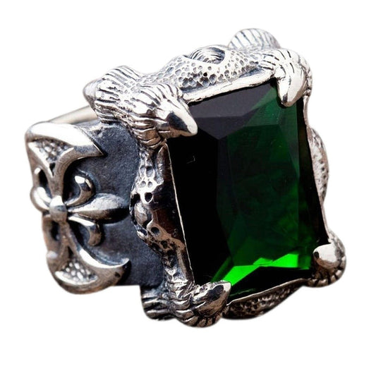 A solid sterling silver green dragon claw ring featuring a large emerald green gemstone held by detailed talons.