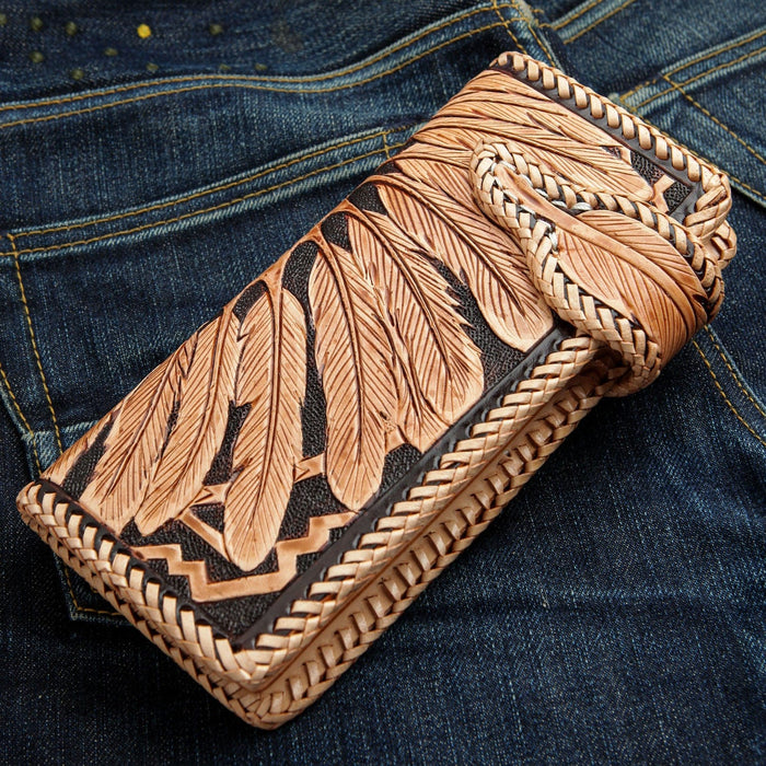 The back of the hand-carved wallet, showing the intricate detail of the chief's feather headdress.