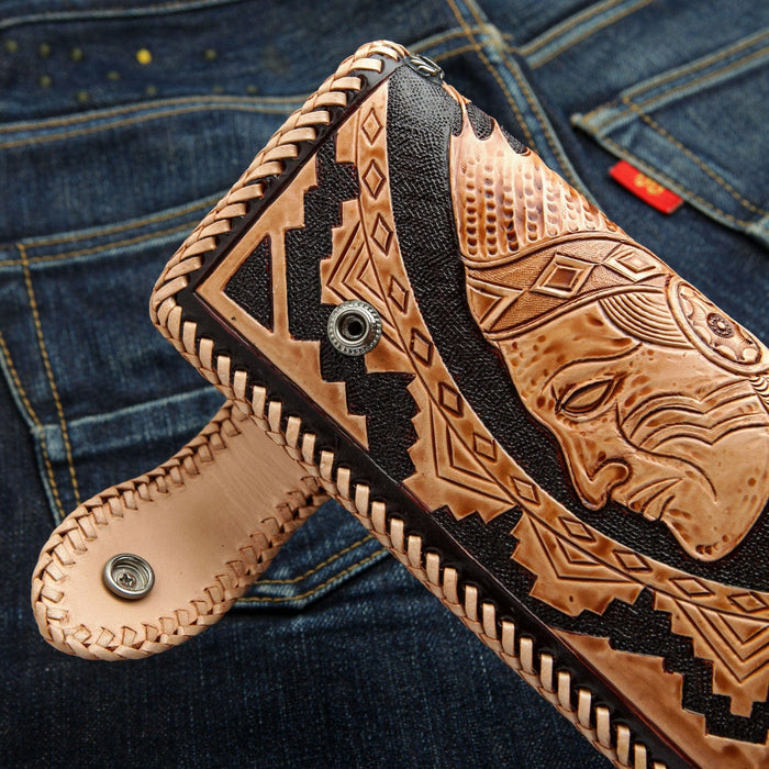 A flat, open view of the tooled leather biker wallet, showing the Indian chief and full feather headdress carving.