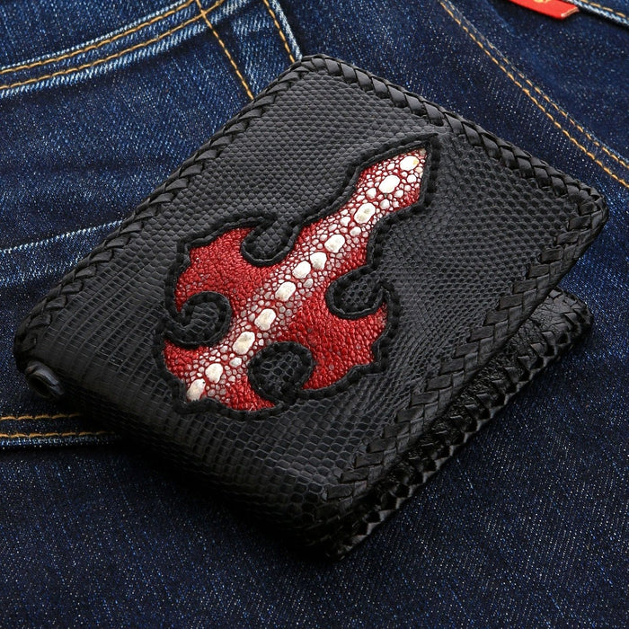 A front view of the handmade black lizard skin wallet featuring a red stingray leather cross inlay.