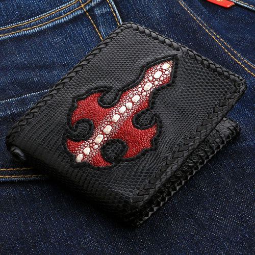A front view of the handmade black lizard skin wallet featuring a red stingray leather cross inlay.
