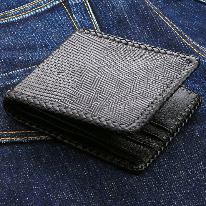 Braided lacing runs the edges and the card slots alike, the reptile grain catching light on blue denim.