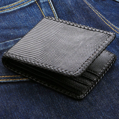 Braided lacing runs the edges and the card slots alike, the reptile grain catching light on blue denim.
