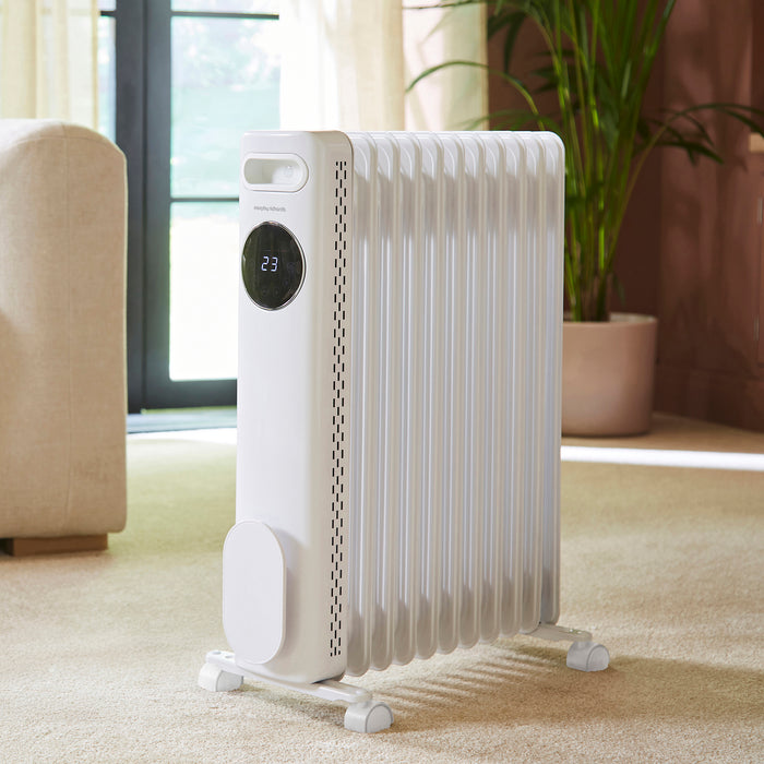 White electric radiator with digital display in a living room setting